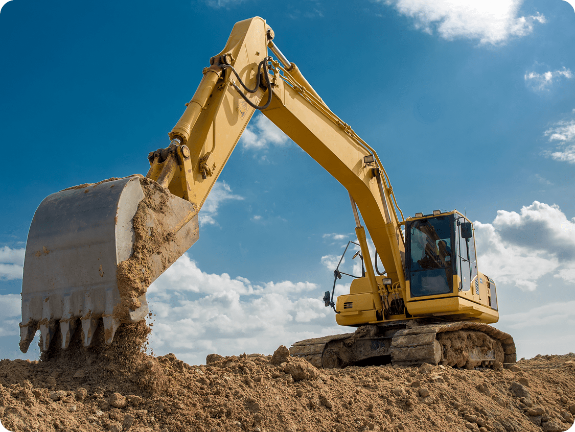 Yellow excavator digging earth under blue sky.